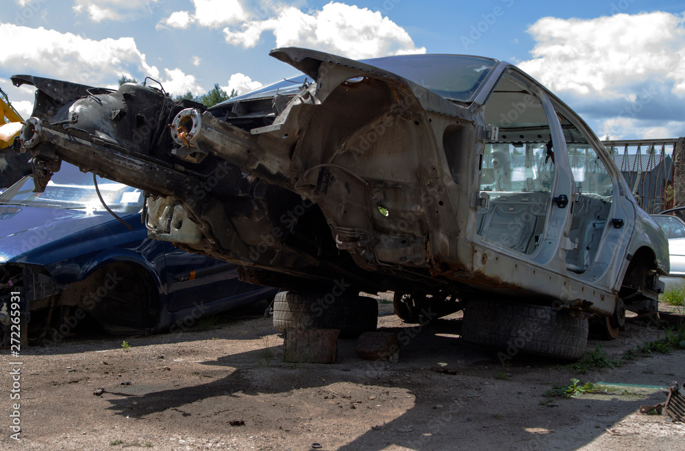disassembled car on the street without a motor and doors disassembled car on the street without a motor and doors