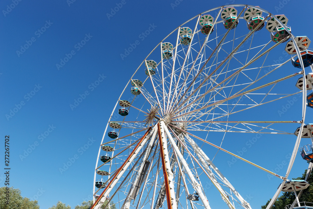Big ferris wheel in front of blue sky in summer