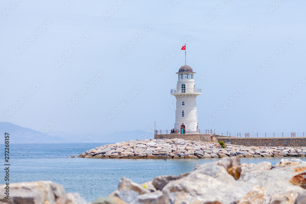 A white lighthouse stands on the coast of Alanya, Turkey.