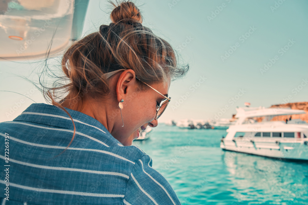 Fototapeta premium Cruise ship vacation woman enjoying travel vacation at sea. Free carefree happy girl looking at ocean or sea. Woman on a yacht enjoying the beautiful vacation.