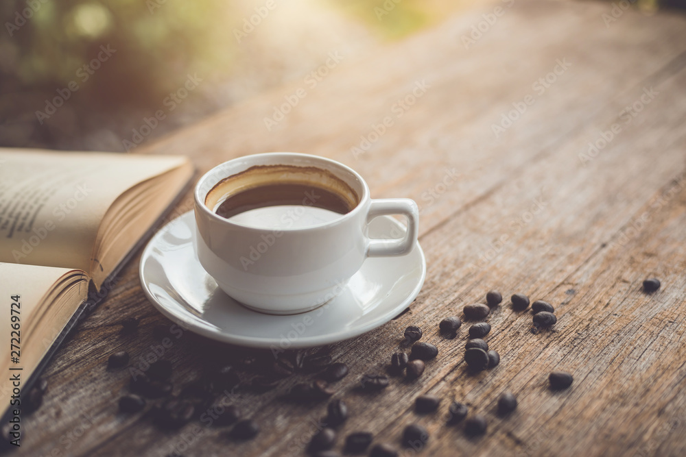 White ceramic coffee cup of black hot americano on wooden table White ceramic coffee cup of black hot americano on wooden table