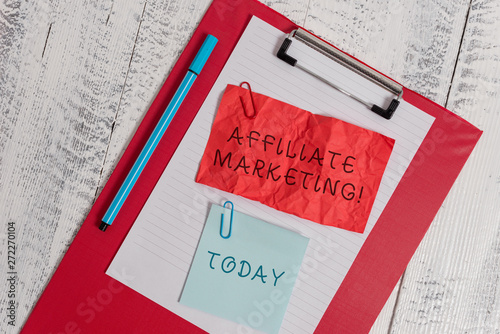 Writing note showing Affiliate Marketing. Business concept for Promoting another demonstratings product Earning a Commission Clipboard paper sheet crushed sticky note clip marker wooden background photo