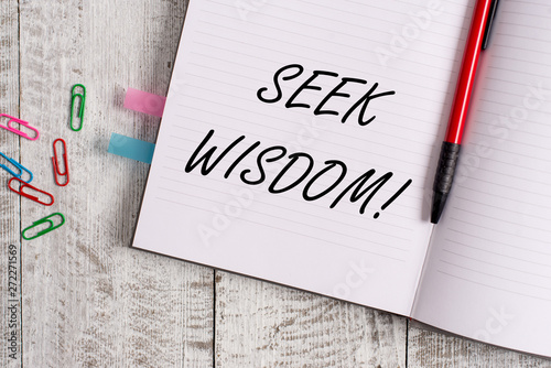 Conceptual hand writing showing Seek Wisdom. Concept meaning ability to think act using knowledge experience understanding Notebook stationary placed above classic wooden backdrop photo