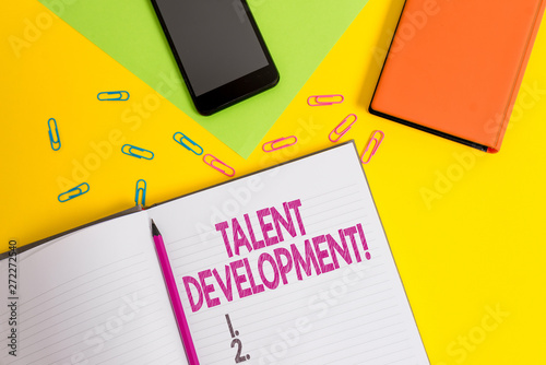 Handwriting text Talent Development. Conceptual photo Building Skills Abilities Improving Potential Leader Blank paper sheet pencil clips smartphone two notepads colored background