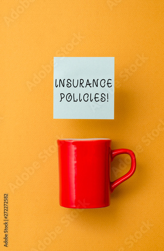 Conceptual hand writing showing Insurance Policies. Concept meaning Documented Standard Form Contract Financial Reimbursement Front view coffee cup colored sticky note yolk color background photo