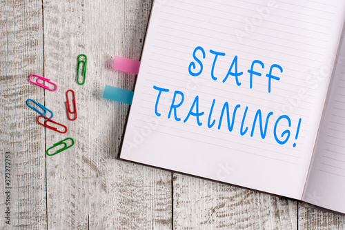 Text sign showing Staff Training. Business photo text learn specific knowledge improve perforanalysisce in current roles Thick pages notebook stationary placed above classic look wooden backdrop photo