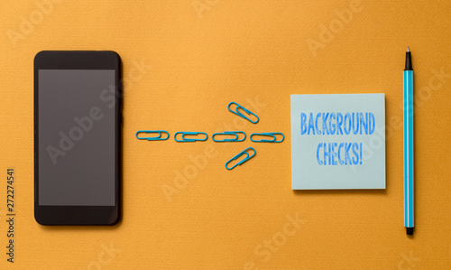 Writing note showing Background Checks. Business concept for looking up compiling criminal records for Organization Colored sticky note clips smartphone pen trendy cool pastel background photo