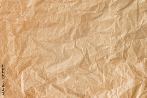 Crumpled gold paper background texture. Brown crumpled paper background