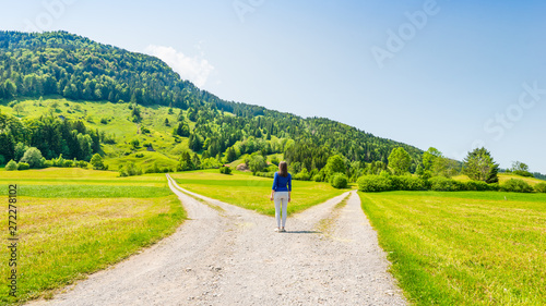 A choice of two ways. Woman at a crossroads.