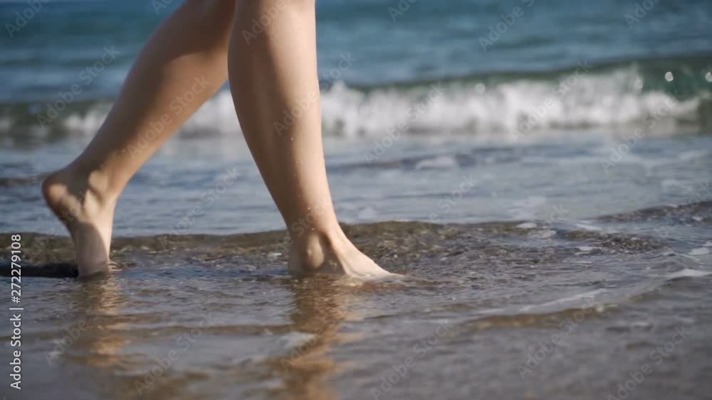 Female feet of hiker tourist walking barefoot on shore at sunset. Female feet of hiker tourist walking barefoot on shore at sunset.