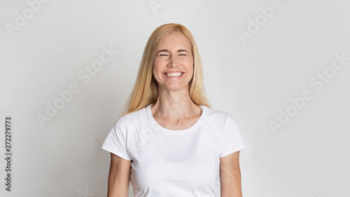 Happy Middle-Aged Woman Smiling With Closed Eyes