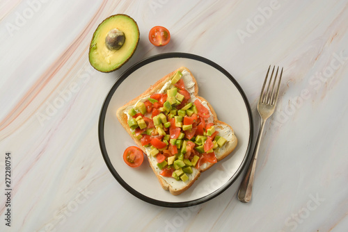 Toast with cream cheese, avocado and cherry tomatoes. Healthy food.