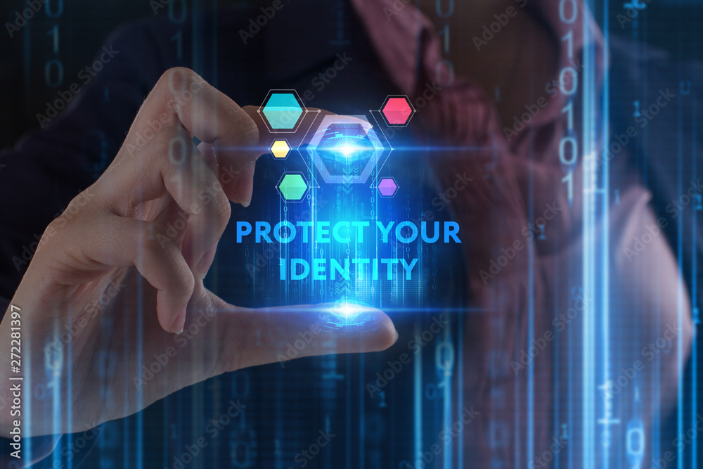 The concept of business, technology, the Internet and the network. A young entrepreneur working on a virtual screen of the future and sees the inscription: Protect your identity The concept of business, technology, the Internet and the network. A young entrepreneur working on a virtual screen of the future and sees the inscription: Protect your identity