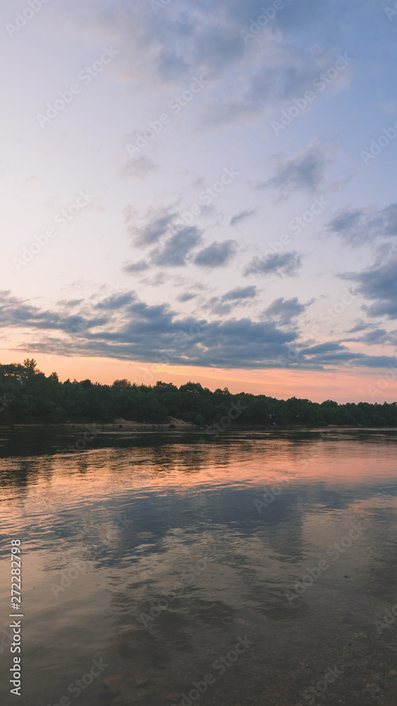 Fototapeta premium beautiful sunset over the river, flying seagulls