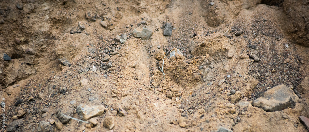 Horizontal background of industrial sand with stones, soft focus Horizontal background of industrial sand with stones, soft focus