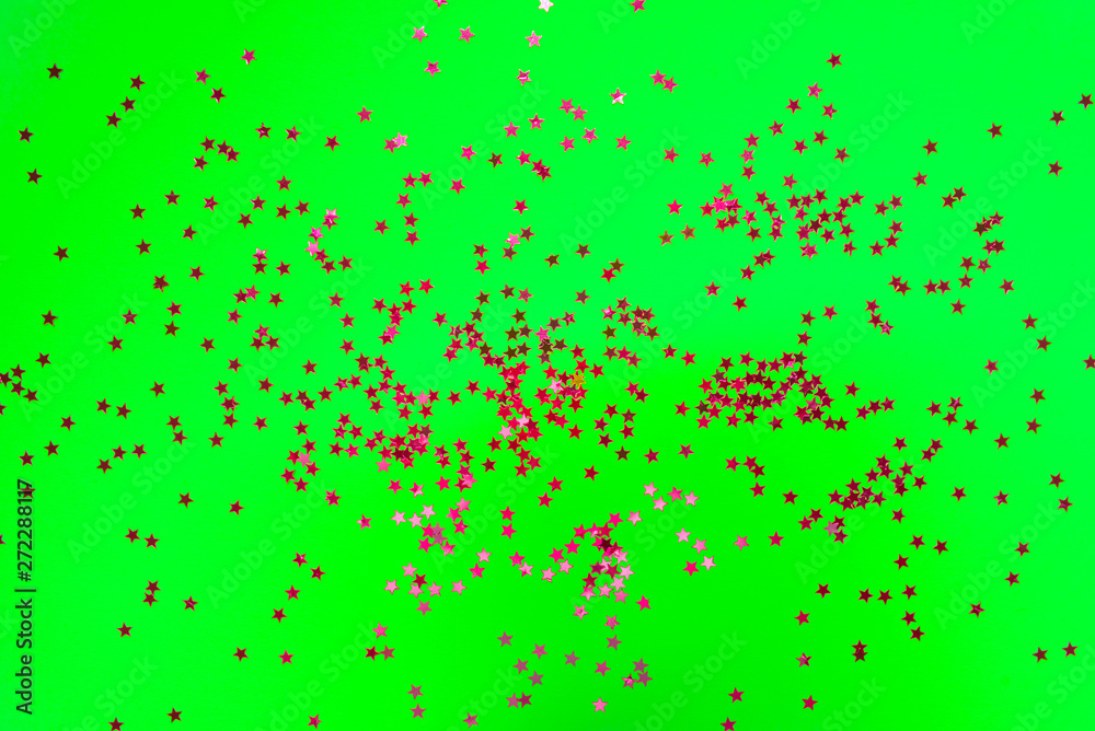 Bright pink stars on UFO green neon background. Trendy colours 2019.