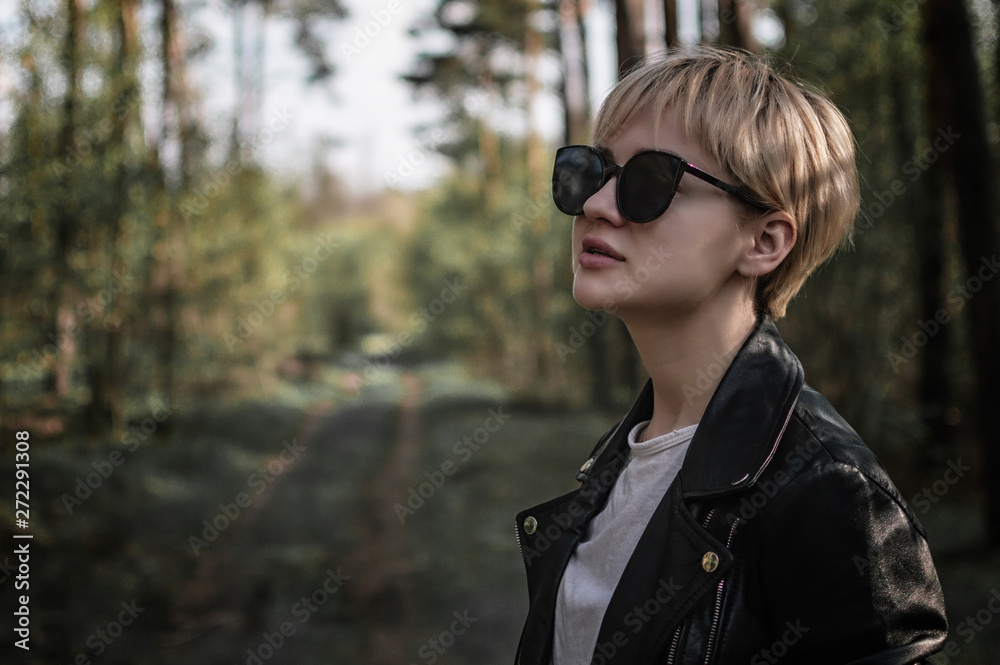 girl in sunglasses in the forest