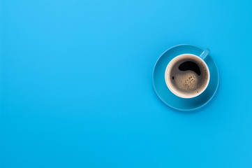 Blue coffee cup over blue background