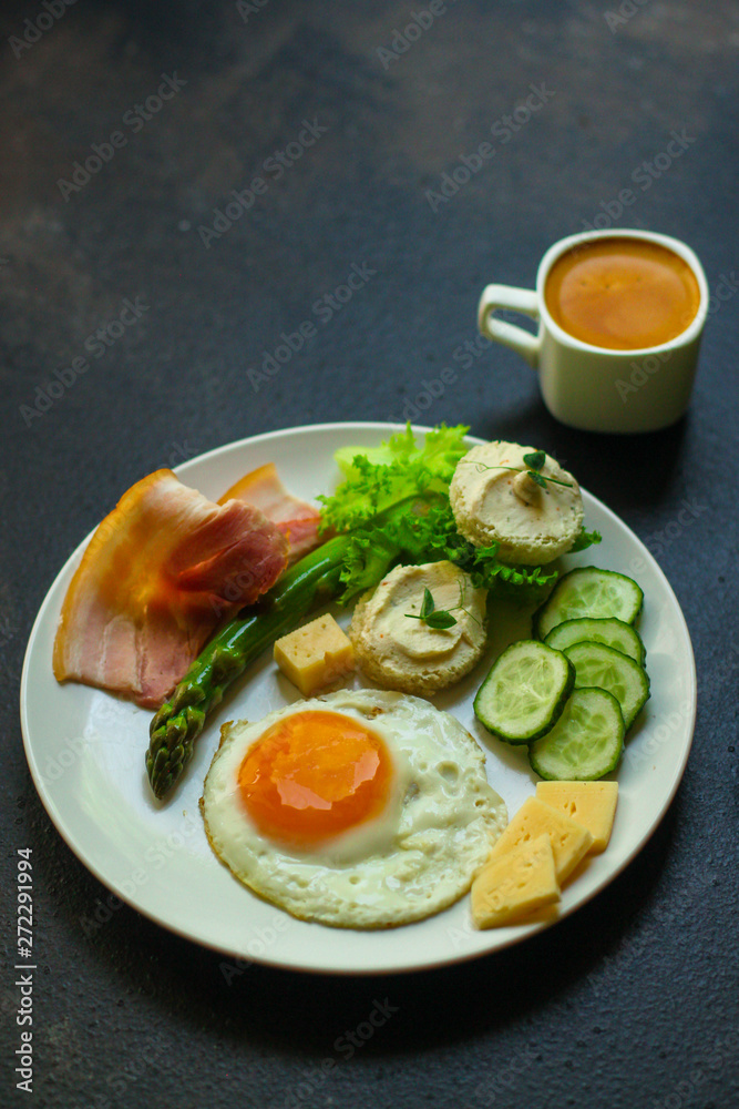 healthy food - breakfast (scrambled eggs, bacon, lettuce, asparagus, cucumbers, cheese, sandwich). food background. top view. copy space healthy food - breakfast (scrambled eggs, bacon, lettuce, asparagus, cucumbers, cheese, sandwich). food background. top view. copy space