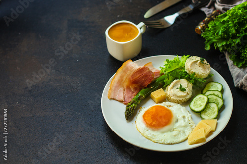 healthy food - breakfast (scrambled eggs, bacon, lettuce, asparagus, cucumbers, cheese, sandwich). food background. top view. copy space