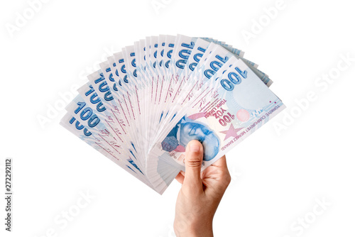 Fototapeta Naklejka Na Ścianę i Meble -  Human hand holding Turkish money. Isolated on white background.