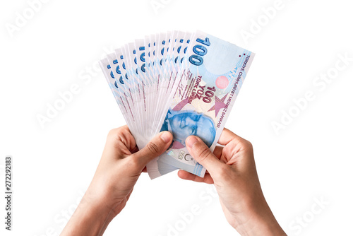 Fototapeta Naklejka Na Ścianę i Meble -  Human hand holding Turkish money. Isolated on white background.