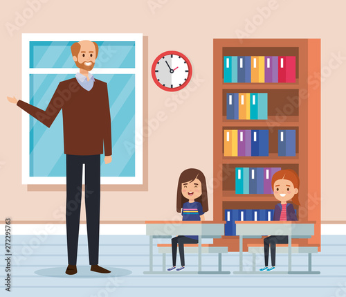 man teacher with kids in the classroom and bookcase