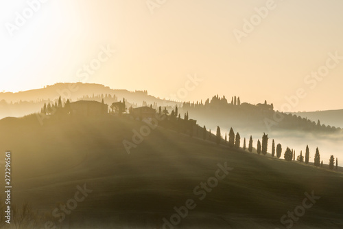 sunrise over a fields and hills in Tuscany