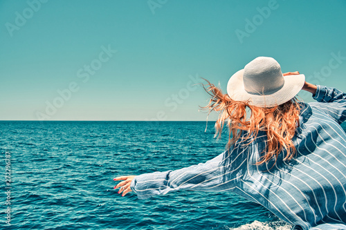 Cruise ship vacation woman enjoying travel vacation at sea. Free carefree happy girl travel at ocean or sea. Woman on a yacht enjoying the beautiful vacation.