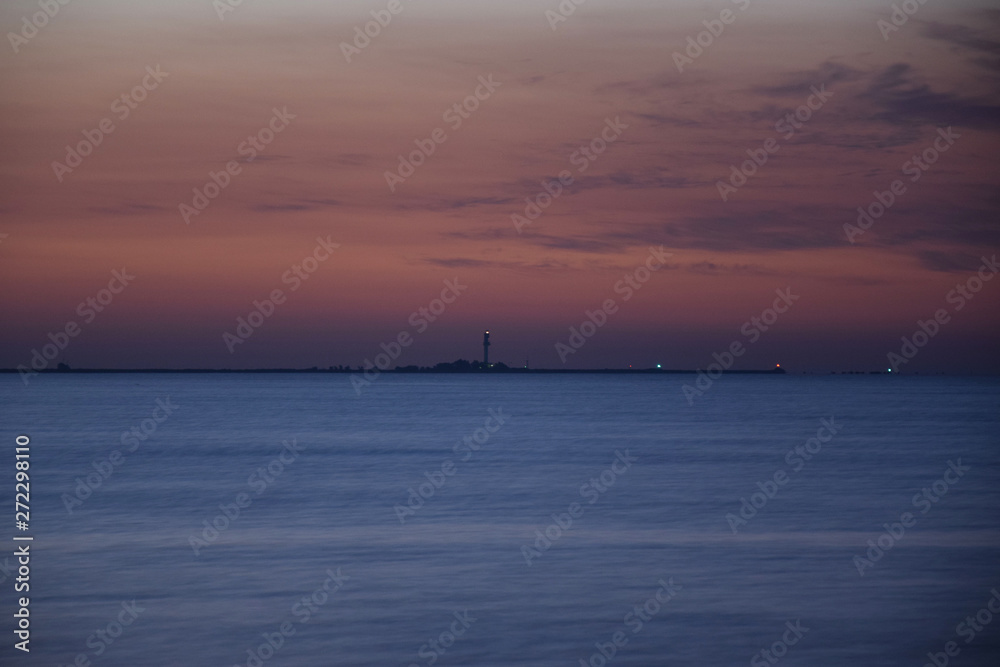 Lighthouse near Sulina estuary. Danube end in Black Sea. Danube biosphere reserve - Danube delta, Romania.