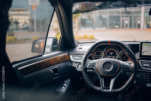 Modern car interior with steering wheel and side window curtains sunshades