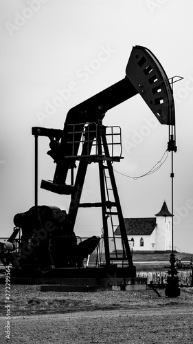 Oil Pump Jacks pumping oil with a church in the background