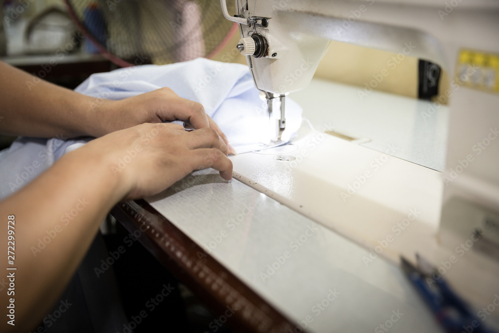 Closeup, Tailor working cutting fabric to a new coat with textile