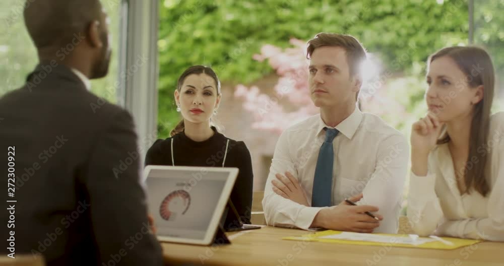 4K Nervous businessman at job interview talking in front of serious management team. Slow motion. 4K Nervous businessman at job interview talking in front of serious management team. Slow motion.