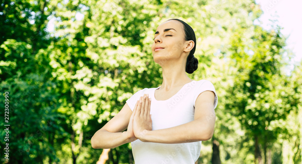 Yoga for good health and strong body. Young beautiful woman doing yoga outdoor in park. Girl is stretching and meditating. Yoga for good health and strong body. Young beautiful woman doing yoga outdoor in park. Girl is stretching and meditating.
