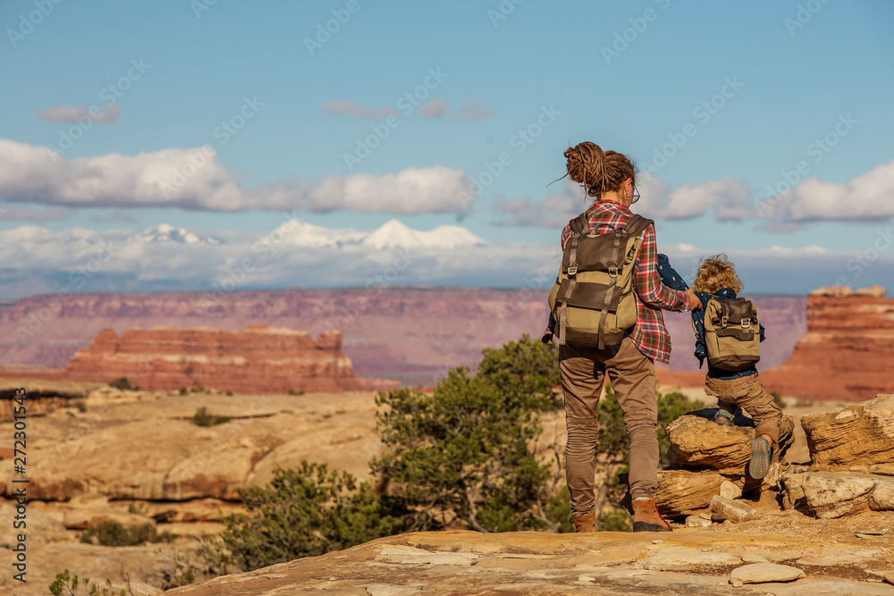 Hiker with boy in Canyonlands National park, needles in the sky, in Utah, USA