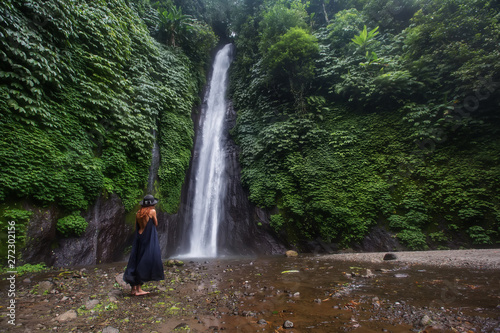 Woman near waterfal on Bali  Indonesia  