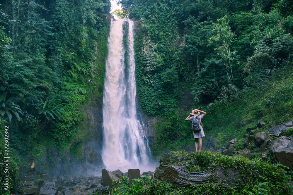  Woman near waterfal Git Git on Bali, Indonesia 