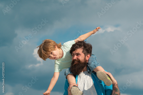 Happy loving family - Father and son. Dream of flying. Happy family father and child on meadow with a kite in the summer on the nature.