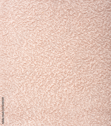 The texture of the fabric is light pink terry towel. Terry cloth as a background.
