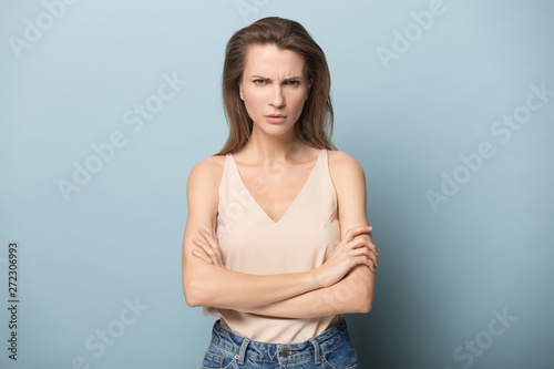 Dissatisfied millennial woman showing angry face expression.
