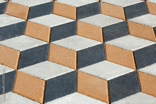 The surface is paved with colored diamond shaped road tiles. perspective view.