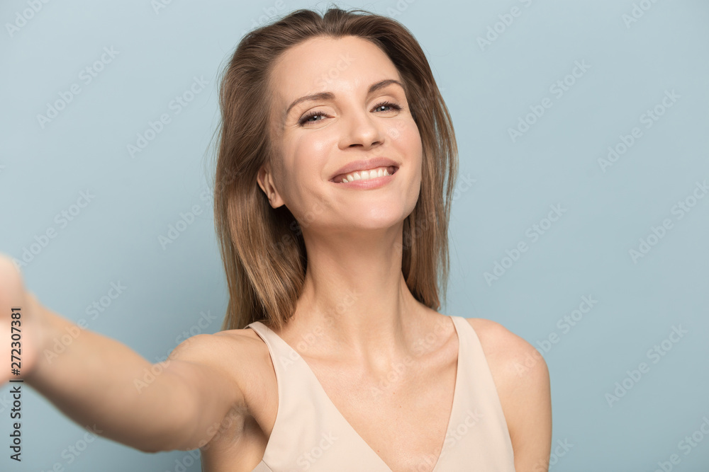 Happy smiling isolated young woman making selfie shot. Happy smiling isolated young woman making selfie shot.