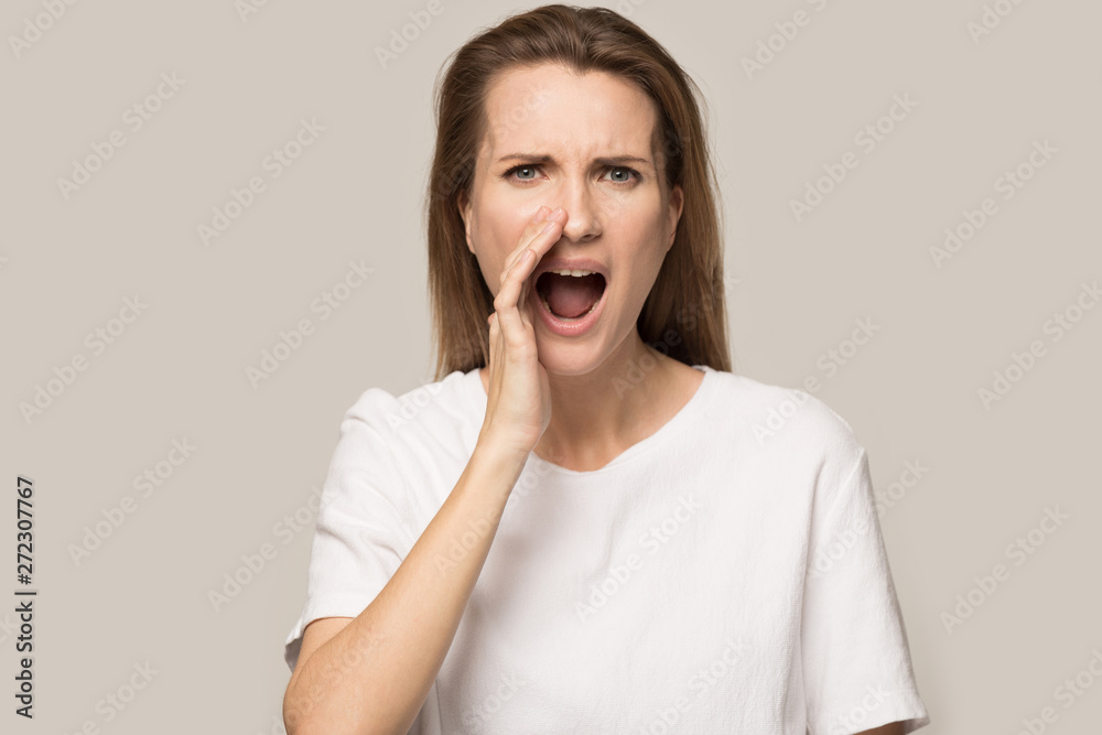Emotional woman holding hand near mouth, shouting speaking loud Emotional woman holding hand near mouth, shouting speaking loud