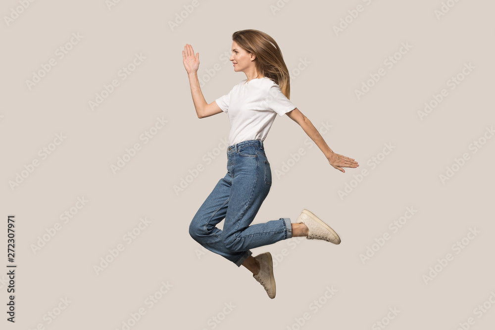 Happy excited attractive young woman jumping, funny activity Happy excited attractive young woman jumping, funny activity