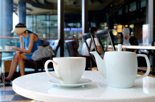 White porcelain tea set served on cafe s round table