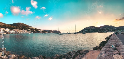 Fototapeta Naklejka Na Ścianę i Meble -  Idyllic old town harbor view with restaurants and sailing boats ans sunset over the hills on a summer day evening. Perfect travel location on the balearic islands. Port d’Andratx, Port Andratx