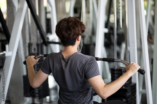 young man exercising with weightlifting in fitness gym