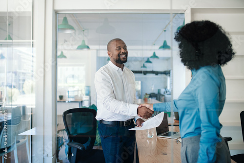 Smiling manager welcoming a new employee to the office