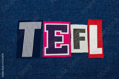 TEFL text word collage, multi colored fabric on blue denim, teach english as a foreign language acronym, horizontal aspect photo
